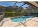 Inviting screened-in pool with clear blue water, and a safety handrail for easy access at 1017 Gould Pl, Oviedo, FL 32765