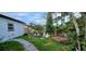 Image shows a backyard with a garden, sidewalk, and plants at 10928 Tangora St, Orlando, FL 32825