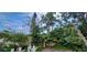 Backyard with dense vegetation, banana trees, and lush foliage at 10928 Tangora St, Orlando, FL 32825