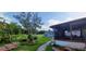 Backyard with covered patio, shed, banana trees and lawn at 10928 Tangora St, Orlando, FL 32825