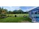 View of backyard shed with mural, chain link fence, and lawn at 10928 Tangora St, Orlando, FL 32825