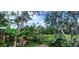 Backyard with dense vegetation, banana trees, and blue sky at 10928 Tangora St, Orlando, FL 32825