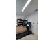 Picture showcases the basement area including storage shelves and a treadmill at 10928 Tangora St, Orlando, FL 32825
