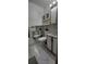 Bathroom featuring a toilet, vanity with mirror and decorative accent at 10928 Tangora St, Orlando, FL 32825