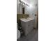 Bathroom featuring a vanity with storage, tiled floors, and a large mirror at 10928 Tangora St, Orlando, FL 32825