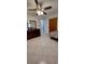 Bedroom featuring neutral tile flooring, a dark dresser, and a ceiling fan at 10928 Tangora St, Orlando, FL 32825