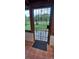 Covered patio's gated entryway featuring decorative ironwork and a welcome mat at 10928 Tangora St, Orlando, FL 32825