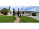 Inviting home with a brick walkway, well-manicured lawn, and attached garage at 10928 Tangora St, Orlando, FL 32825