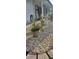 Close-up view of the front garden with small rocks and mature plants at 10928 Tangora St, Orlando, FL 32825