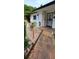 Inviting front porch area with stone accents, decorative plants, and a secure gated entry at 10928 Tangora St, Orlando, FL 32825