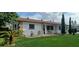 Charming single-story home with a well-maintained front yard, stone accents, and lush landscaping at 10928 Tangora St, Orlando, FL 32825