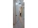 Hallway with neutral tile flooring and white paneled doors, exuding a clean and simple aesthetic at 10928 Tangora St, Orlando, FL 32825