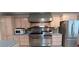 Kitchen with light wood cabinets, stainless steel oven range and refrigerator at 10928 Tangora St, Orlando, FL 32825