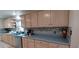 Traditional kitchen with light wood cabinets, stainless steel dishwasher, and blue countertops at 10928 Tangora St, Orlando, FL 32825