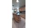 Spacious kitchen featuring a kitchen island with ample cabinet storage and stainless steel appliances at 10928 Tangora St, Orlando, FL 32825
