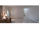 Open-concept living area featuring tile flooring, a decorative front door, and access to other rooms at 10928 Tangora St, Orlando, FL 32825