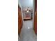 View of bedroom showing tile floors, bed, dresser and closet beyond folding closet doors at 10928 Tangora St, Orlando, FL 32825