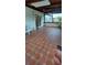 Relaxing screened patio with patterned tile flooring and views of the surrounding yard at 10928 Tangora St, Orlando, FL 32825