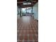Enclosed patio featuring patterned tile flooring, wood-beamed ceiling, and bright natural light from surrounding windows at 10928 Tangora St, Orlando, FL 32825