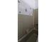 Shower with a mix of vintage green tile and white tile and painted with floral design at 10928 Tangora St, Orlando, FL 32825