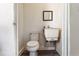 Small bathroom with a white toilet, sink, mirror and flooring, offering functionality at 1104 W Marjorie St, Lakeland, FL 33815