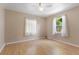 Bright bedroom features light-colored wood floors and two windows bringing in natural light at 1104 W Marjorie St, Lakeland, FL 33815