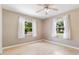 This bright bedroom offers neutral walls, wood flooring, and windows that bring in ample light at 1104 W Marjorie St, Lakeland, FL 33815
