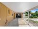 Spacious covered parking area with an open garage door and a view of a fenced backyard at 1104 W Marjorie St, Lakeland, FL 33815