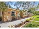 Charming home exterior with stone accents, decorative metalwork, and manicured landscaping at 1104 W Marjorie St, Lakeland, FL 33815