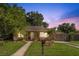 Charming single-story home featuring a well-kept lawn, mailbox, and a gated carport at 1104 W Marjorie St, Lakeland, FL 33815