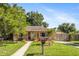 Charming single-story home featuring a well-kept lawn, mailbox, and a gated carport at 1104 W Marjorie St, Lakeland, FL 33815