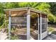 Cozy outdoor gazebo with screened walls, elegant rug, and lush green foliage surrounding it at 1104 W Marjorie St, Lakeland, FL 33815