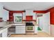 Classic kitchen with white cabinetry, stainless steel oven, and open access to next room at 1104 W Marjorie St, Lakeland, FL 33815