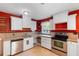 Classic kitchen with white cabinetry, stainless steel appliances, and neutral countertops at 1104 W Marjorie St, Lakeland, FL 33815