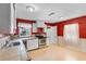 Bright kitchen offering stainless appliances, light wood floors, and white lower wall accent at 1104 W Marjorie St, Lakeland, FL 33815