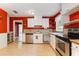 Traditional kitchen with stainless steel appliances, bright white cabinets, and red accent walls at 1104 W Marjorie St, Lakeland, FL 33815
