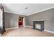 Empty living room with gray walls, a fireplace, light wood flooring, and view to front door at 1104 W Marjorie St, Lakeland, FL 33815