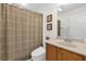 Bathroom with sink, toilet, decorative shower curtain, and coordinated accessories at 1254 Spartanburg Way, The Villages, FL 32162