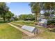 Community area with manicured lawn, trees, shuffleboard and gazebo at 1254 Spartanburg Way, The Villages, FL 32162