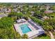 Aerial view of a community pool surrounded by trees and lounge chairs at 1254 Spartanburg Way, The Villages, FL 32162