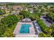 Aerial view of a community pool with lounge chairs surrounded by lush greenery at 1254 Spartanburg Way, The Villages, FL 32162