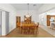 Elegant dining room featuring a wooden table, seating for eight, and a stylish chandelier at 1254 Spartanburg Way, The Villages, FL 32162