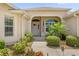 Inviting front porch with beautiful landscaping and a pathway leading to the front door at 1254 Spartanburg Way, The Villages, FL 32162