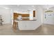 Modern kitchen with tile flooring, breakfast bar, and ample counter space, perfect for cooking and entertaining at 1254 Spartanburg Way, The Villages, FL 32162