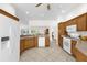 Large kitchen with stainless steel appliances, ample cabinets, and a breakfast bar at 1254 Spartanburg Way, The Villages, FL 32162