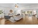 Bright living room with wood floors, neutral decor, and sliding doors to the lanai at 1254 Spartanburg Way, The Villages, FL 32162