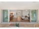 View from the sunroom showcases an open floor plan with living room, dining area, and kitchen at 1254 Spartanburg Way, The Villages, FL 32162