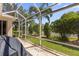 Covered lanai enclosed with screen featuring well-maintained lawn at 1254 Spartanburg Way, The Villages, FL 32162