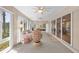 Spacious sunroom with seating area and sliding doors that open up to various rooms in the home at 1254 Spartanburg Way, The Villages, FL 32162
