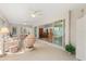 Spacious sunroom with seating area and sliding doors that open up to various rooms in the home at 1254 Spartanburg Way, The Villages, FL 32162